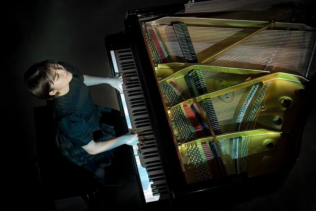 A pianist at a Shigeru Kawai grand piano, seen from above